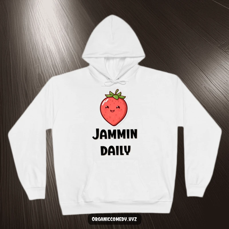 Funny, round, smiling strawberry character joyfully bouncing, featured on a cozy hoodie.