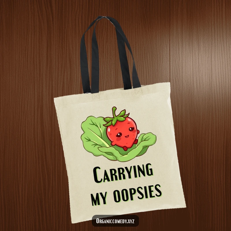 Funny tote bag with a bashful strawberry character tripping over a giant lettuce leaf, ideal for groceries or daily carry.